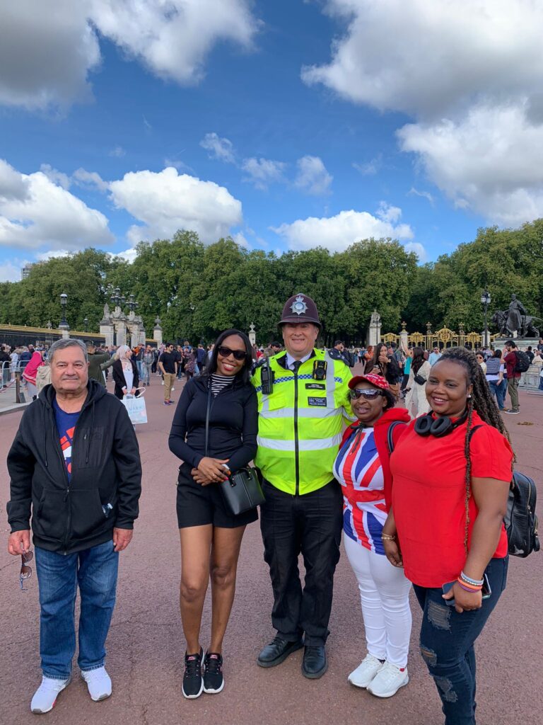People posing for a photo with a police officer