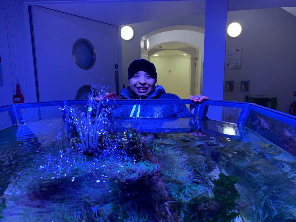 A woman poses for a photo at the aquarium