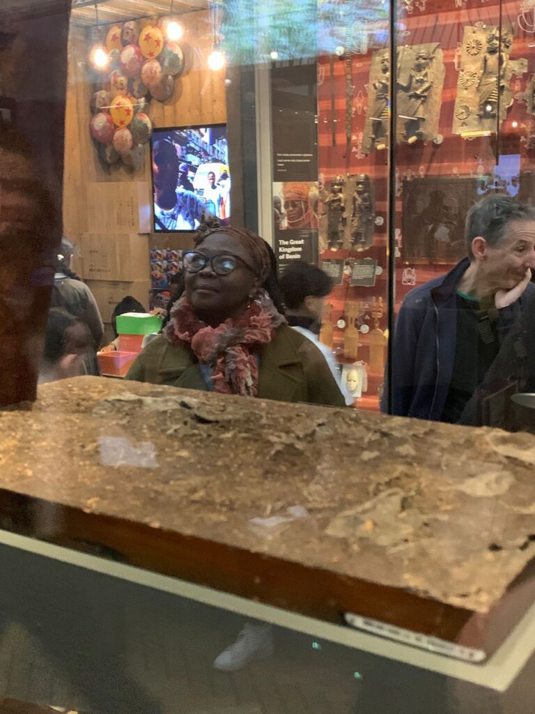 A woman studies a showcase at the Horniman Museum