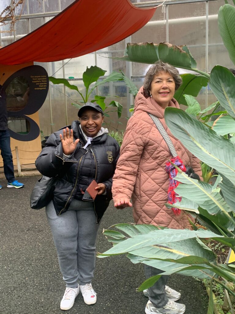 Two people pose for a photo at the Butterfly House at the Horniman Museum