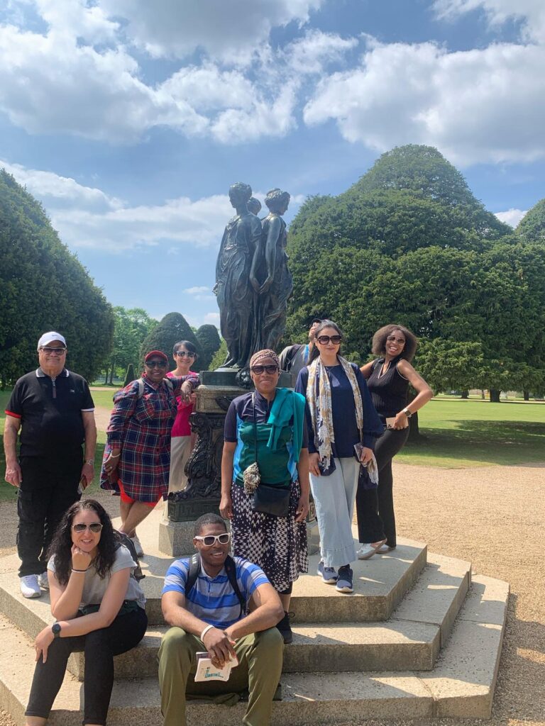 A group of people pose for a photo a Hampton Court Palace